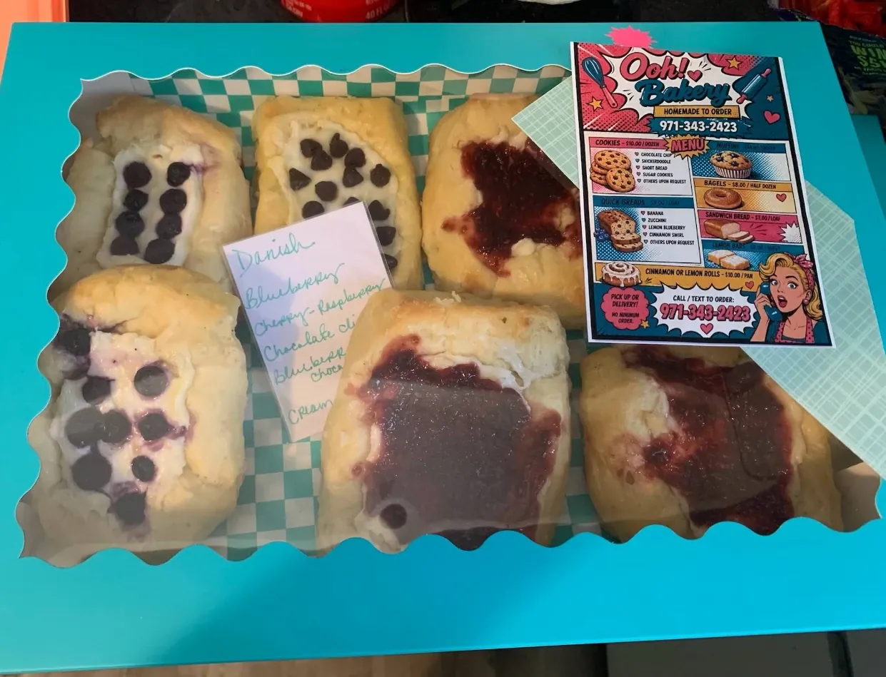 A box of homemade Danish with blueberry, cherry-raspberry and chocolate chip fillings
